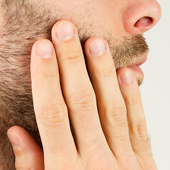 Image showing Close-up of a young man shaving