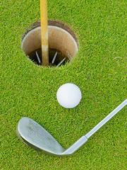 Image showing Golf hole with ball and putt