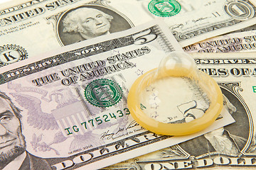 Image showing Condom on the US dollars bills