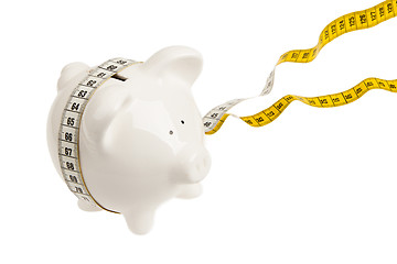 Image showing White piggy bank with measuring tape