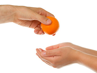 Image showing Giving an orange