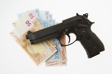 Image showing Semi-automatic gun and money isolated