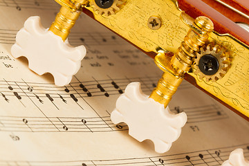 Image showing Old music sheet and a guitar