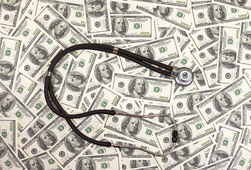 Image showing Stethoscope and dollars