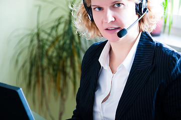 Image showing Business woman with laptop and headset