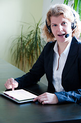 Image showing Business woman with digital tablet PC and headset