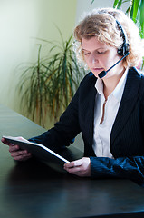 Image showing Business woman with digital tablet PC and headset