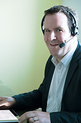 Image showing Businessman with digital tablet PC and headset