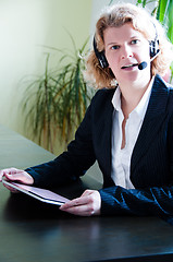 Image showing Business woman with digital tablet PC and headset