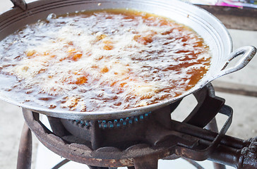 Image showing Chicken deep frying in hot oil