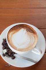 Image showing Cup of hot caffe latte with coffee grain 
