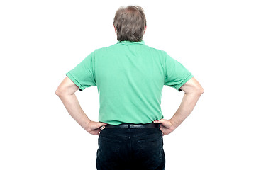 Image showing Back pose of elderly guy with hands on his waist