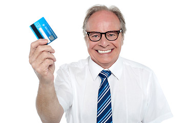 Image showing Cheerful aged employer holding up a cash card