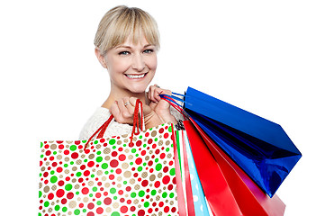 Image showing Pretty female carrying shopping bags over shoulders