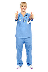 Image showing Cheerful lady doctor showing double thumbs up