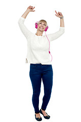 Image showing Joyous middle aged woman dancing to the beat