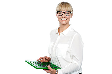 Image showing Secretary using large green calculator