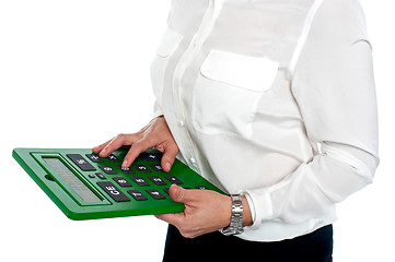 Image showing Woman pressing digit 6 on calculator