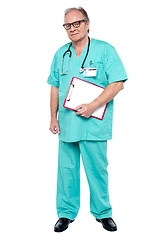 Image showing Portrait of grim faced doctor holding a clipboard