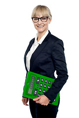 Image showing Confident corporate woman holding calculator
