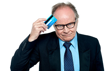 Image showing Businessman scratching his forehead with plastic card