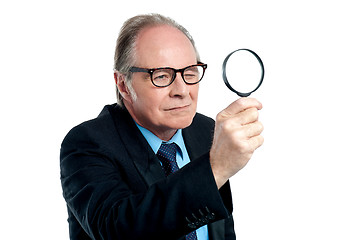 Image showing Detective  exploring through a magnifying glass