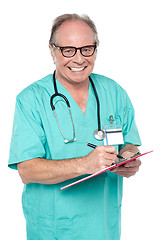 Image showing Cheerful doctor gathering information from patient