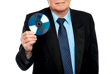 Image showing Cropped image of a male showing compact disk