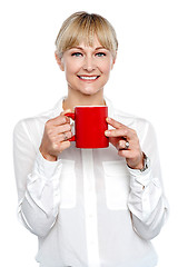 Image showing Female manager posing with coffee mug in hand