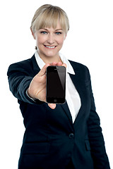 Image showing Sales executive displaying brand new multimedia phone