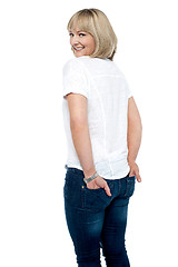 Image showing Smartly dressed woman with hands in back pocket of jeans