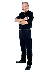 Image showing Happy man in black attire posing with arms folded