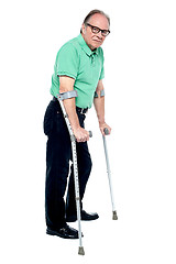 Image showing Physically disabled old man with crutches