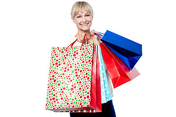 Image showing Vivacious woman holding colorful shopping bags