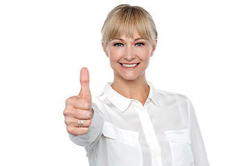 Image showing Blonde woman in formal attire showing thumbs up gesture