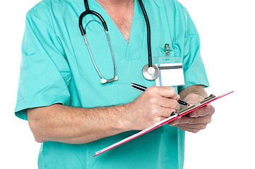 Image showing Medical expert jotting down case sheet notes