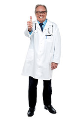 Image showing Successful senior doctor showing thumbs up sign to the camera