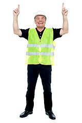 Image showing Experienced construction employee pointing his fingers upwards