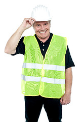 Image showing Matured construction worker holding his safety helmet