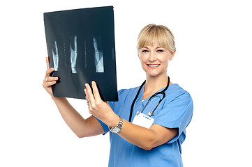 Image showing Lady surgeon holding up x-ray report