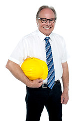 Image showing Smiling experienced architect posing with safety helmet