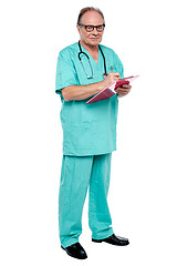 Image showing Male doctor in duty hours writing prescription