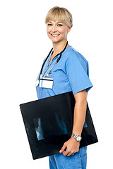 Image showing Nurse holding x-ray sheet to be passed up to a senior doctor