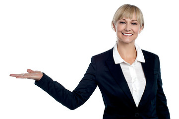 Image showing Cheerful business executive presenting copy space area