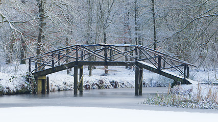 Image showing Wooden bridge covered in snow