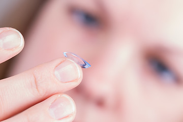 Image showing Close up of inserting a contact lens