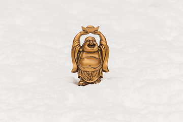 Image showing Small happy Buddha standing in the snow