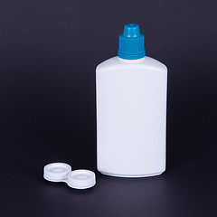 Image showing Lens casing and bottle of water isolated on black