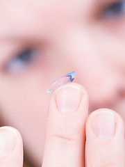 Image showing Close up of inserting a contact lens