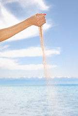 Image showing Woman hand playing with sand